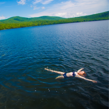 A woman floats in the waters of Moosehead Lake in Greenville, Maine